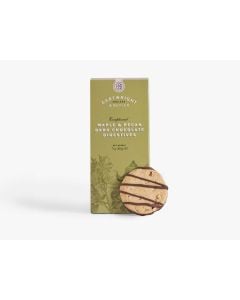 A green box of Cartwright & Butler maple & pecan dark chocolate digestives with illustrations of a tea pot and some plants in dark green with a biscuit that has a chocolate drizzle propped up against the box