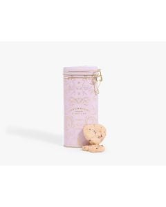 Light pink heart tin with gold clasp of Cartwright & Butler raspberry & white chocolate biscuits with gold designs on the tin. With two heart shaped biscuits propped up against the tin 