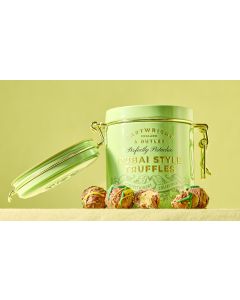 Pistachio Dubai Style Truffles, milk chocolate filled with a creamy pistachio ganache, knafeh crunch, and finished with a vibrant yellow and green drizzle.