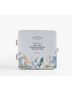 Light blue tin with metal clasp of Cartwright & Butler the tea connoisseur selection with illustrations of leaves and flowers in blue, green, and brown