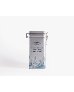 Silver tin with metal clasp of Cartwright & Butler English breakfast tea, with illustrations of leaves in blue