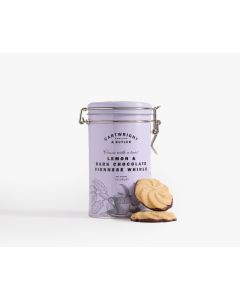 A light purple tin with metal clasp of Cartwright & Butler lemon & dark chocolate Viennese whirls with illustrations of some lemons and a teacup, with two Viennese whirls in front of the tin 