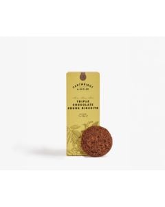 Dark yellow box of Cartwright & Butler triple chocolate chunk biscuits with illustrations of plants in grey. In front of the box is a chocolate biscuit leant against the box