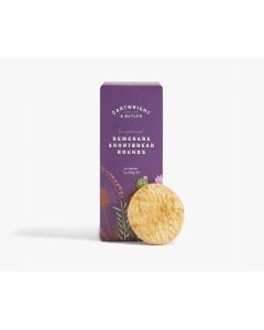 Dark purple box of Cartwright & Butler demerara shortbread rounds with illustrations of different plants in green, pink, and red with a shortbread biscuit leaning against the box