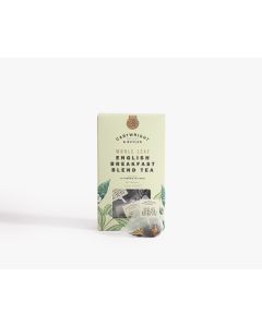 Light green box with small clear window of Cartwright & Butler English breakfast blend tea with illustrations of leaves in green. In front of the box is a tea bag