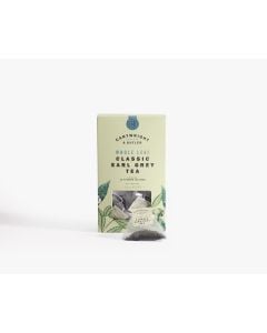 Light green box with small clear window of Cartwright & Butler classic earl grey tea with illustrations of leaves in green. In front of the box is a tea bag