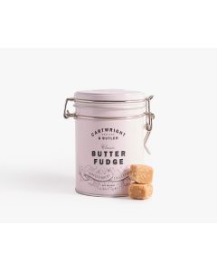 Light pink tin with metal clasp of Cartwright & Butler butter fudge with two pieces of fudge stacked in front