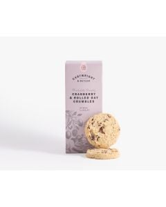 Light pink box of Cartwright & Butler cranberry & rolled oat crumbles with illustrations of plants and a teapot with two biscuits in front of the box