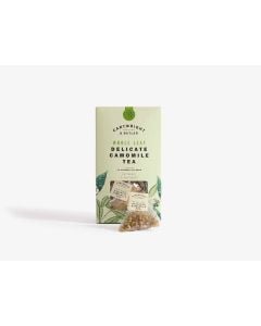 Light green box with small clear window of Cartwright & Butler delicate camomile tea with illustrations of leaves in green. In front of the box is a tea bag