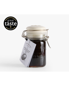 Glass jar with metal clasp and a white tag of Cartwright & Butler red onion chutney with an illustration of an onion on the front of the tag 